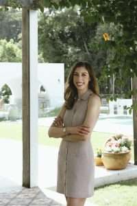 Dr Courtney Stewart, skin nutritionist and women’s health expert, smiling outside a wellness space